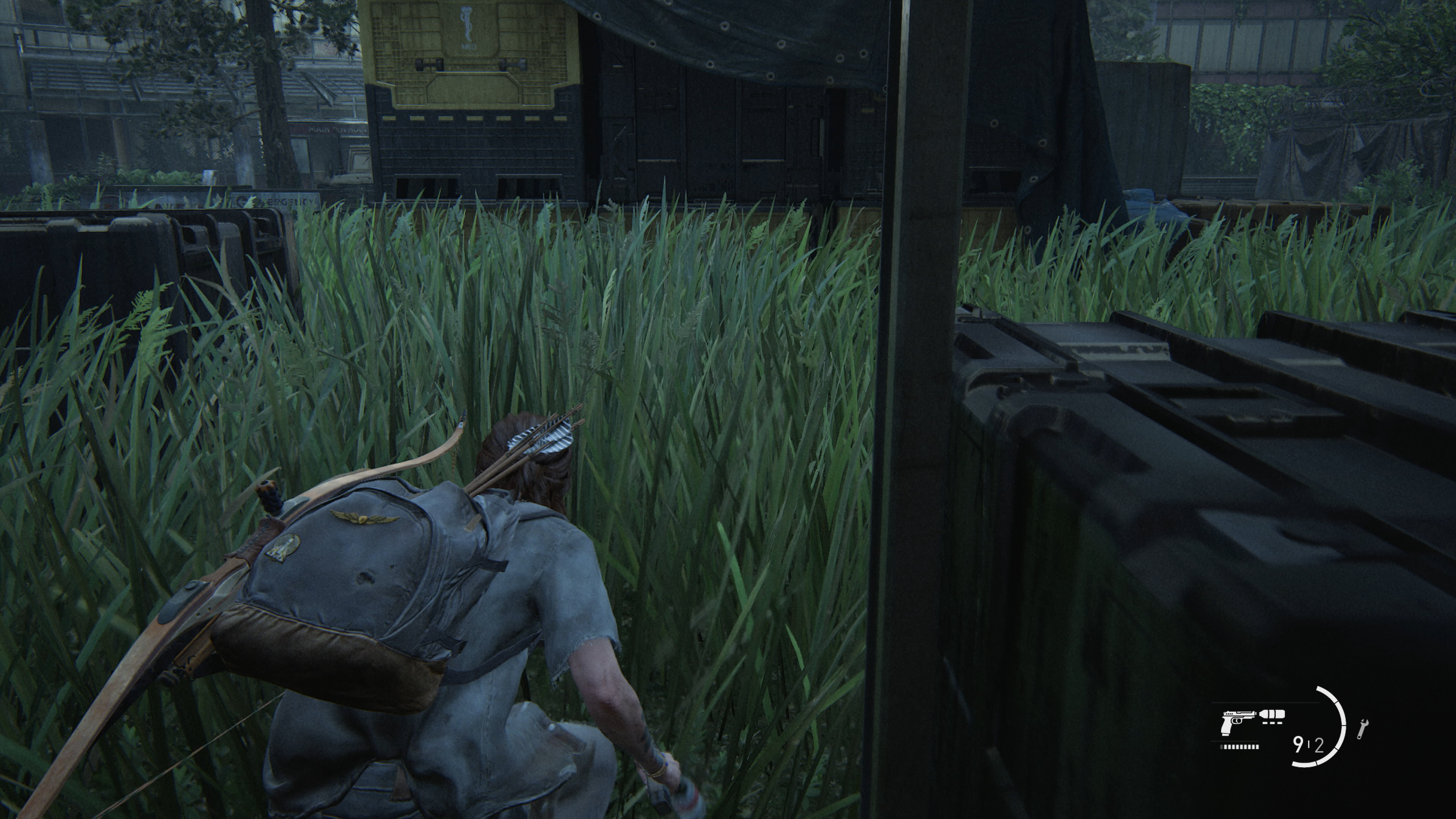 Ellie stealth in the grass from The Last of Us Part II